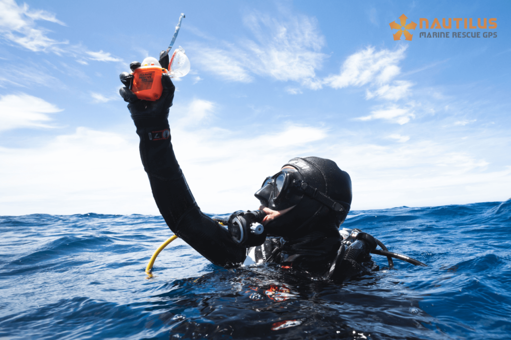 Photo credit: Nautilus Lifeline Scuba diver at the surface holding up a Marine Rescue GPS locator