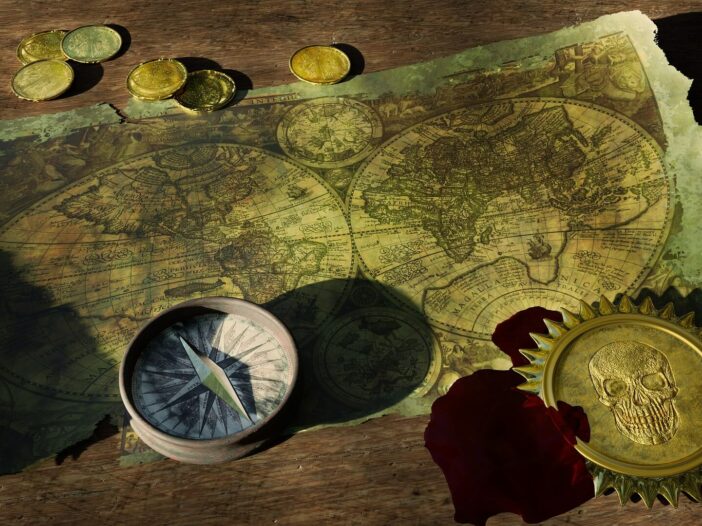 Aged treasure map with compass and gold coins