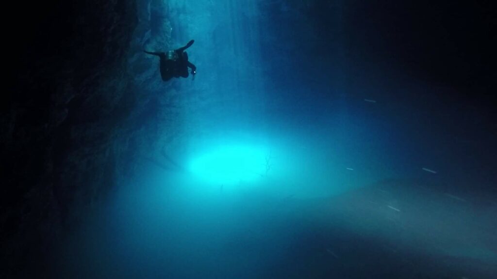 Image from a Cenote Mexico: Photo Credit: Felix Deschenes, Freelance Instructor (Playa Del Carmen, Mexico) Sunlight penetrates a cavern as a diver swims through a cenote in Mexico