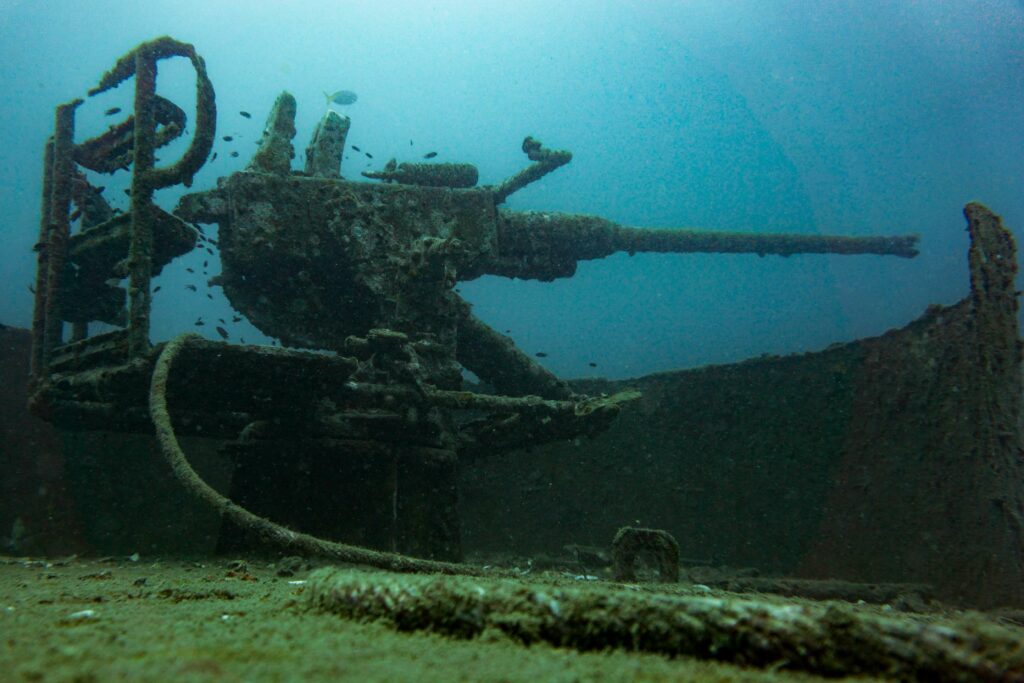 Naval artillery gun on a sunken warship Naval artillery gun on a sunken warship
