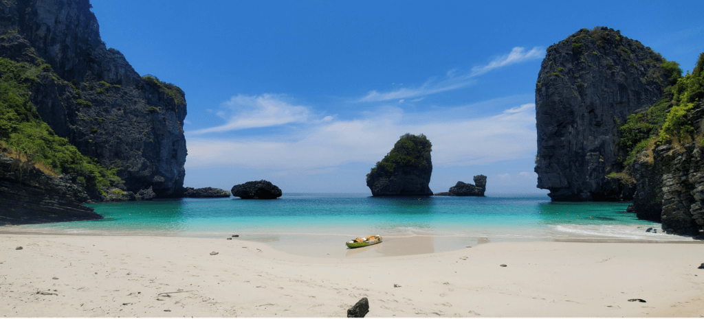 A kayak sits in an empty Nui Bay on Koh Phi Phi, Thailand A kayak sits in an empty Nui Bay on Koh Phi Phi, Thailand