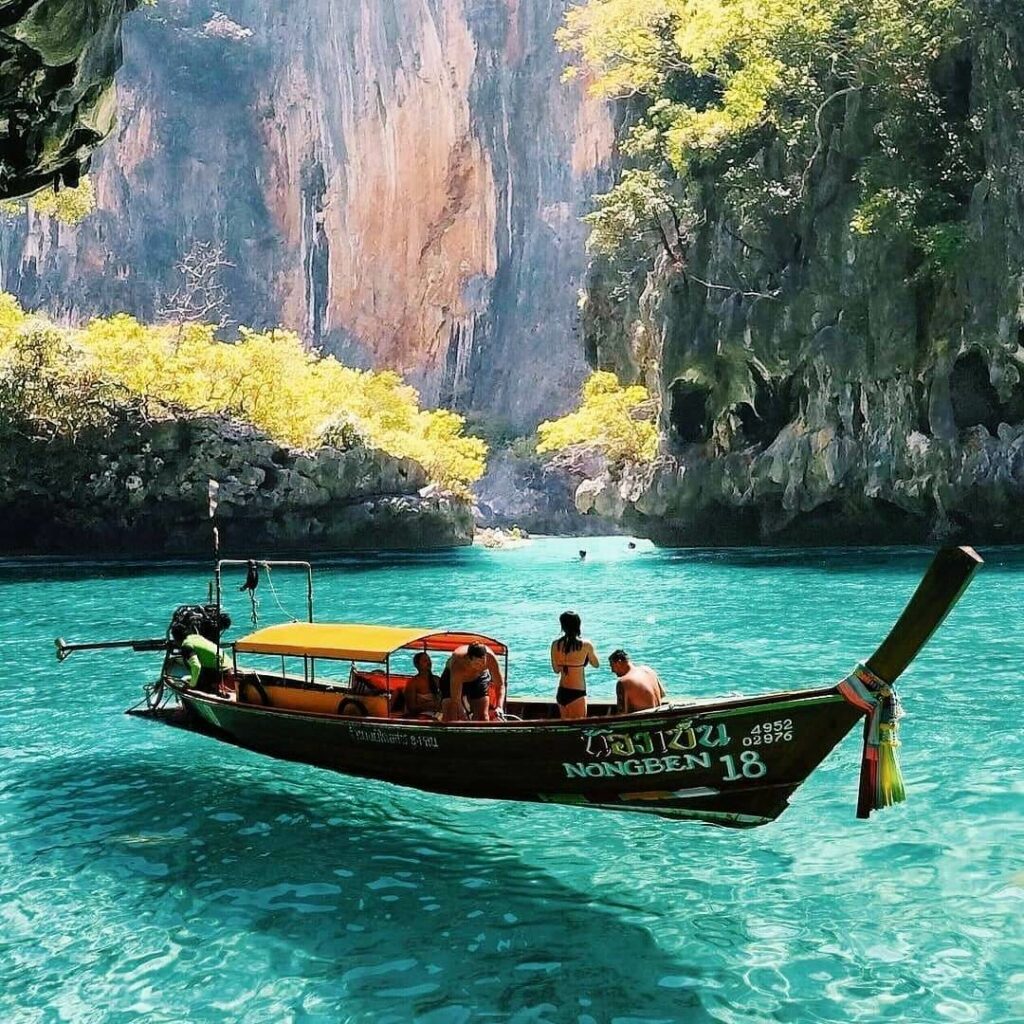 Photo Kindly Provided by Princess Divers Tourists visit the crystal clear waters of Pileh Lagoon on a longtail