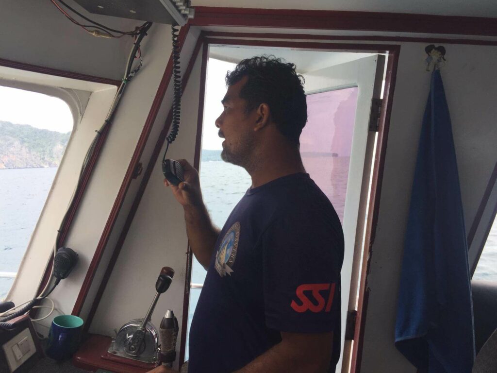 Boat captain issuing a mayday call at sea Boat captain issuing a mayday call at sea