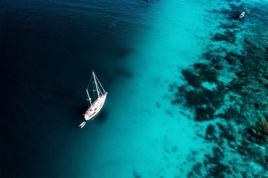 Aerial view of a sailboat on turquoise blue water in Thailand Aerial view of a sailboat on turquoise blue water in Thailand
