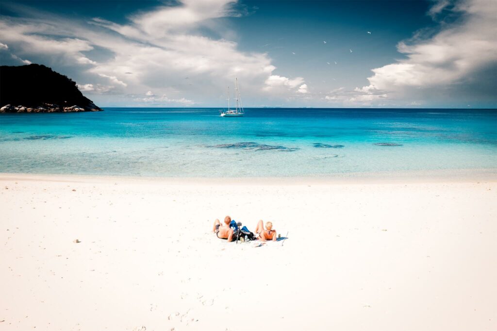 Chris and Jennifer Likins lay on a deserted white sand beach in Thailand Chris and Jennifer Likins lay on a deserted white sand beach in Thailand