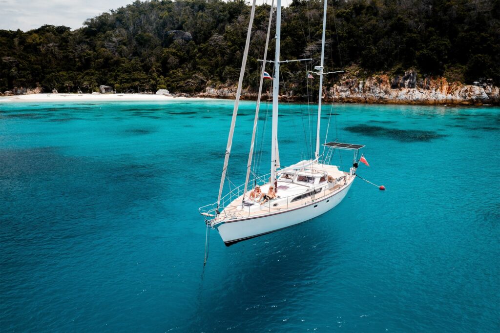 A sailboat with solar panels anchored in Thailand A sailboat with solar panels anchored in Thailand