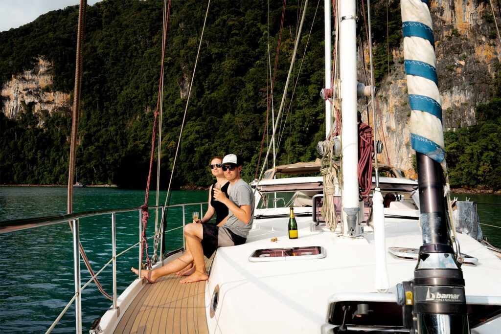 Jennifer Likins and Chris Likins drinking champaign on their sailboat in Thailand Jennifer Likins and Chris Likins drinking champaign on their sailboat in Thailand