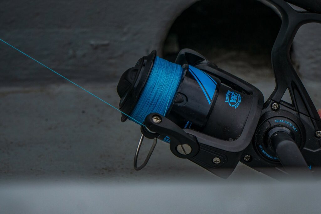 Spinning rod and reel with blue fishing line Spinning rod and reel with blue fishing line