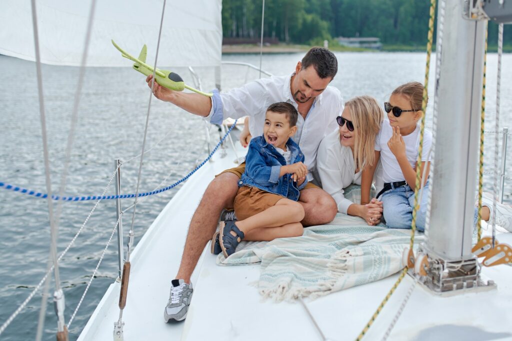 A family enjoying their time on the bow of the boat A family enjoying their time on the bow of the boat