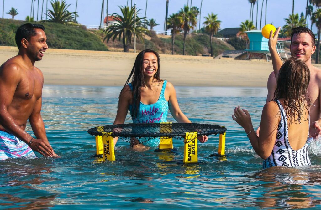 Group plays water games near the beach on a sailing trip Group plays water games near the beach on a sailing trip