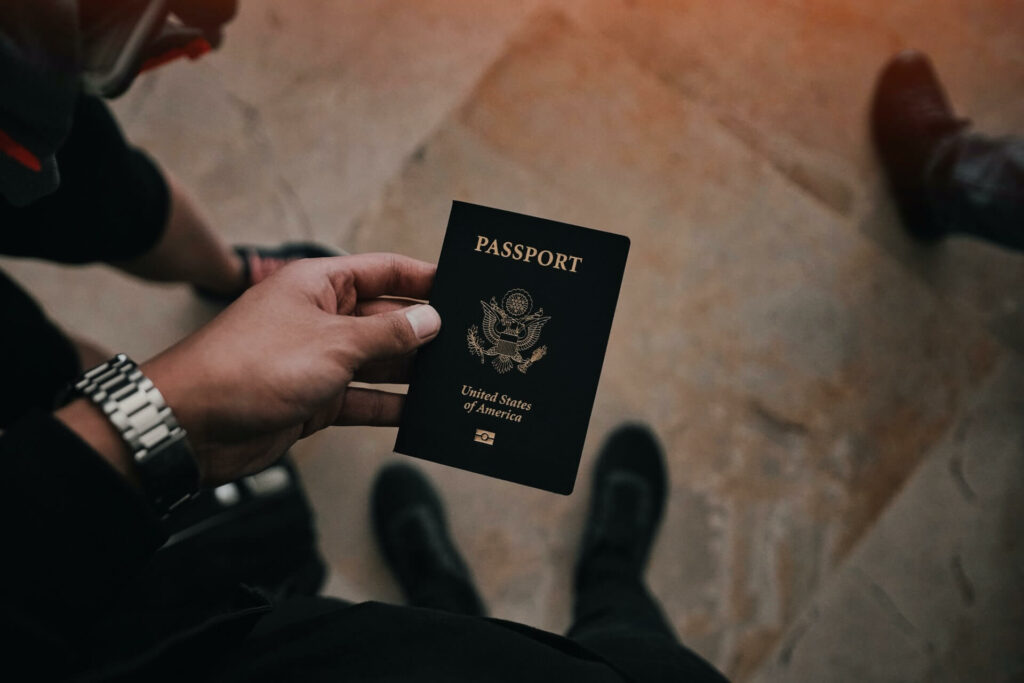 Person holds a passport before a sailing holiday Person holds a passport before a sailing holiday