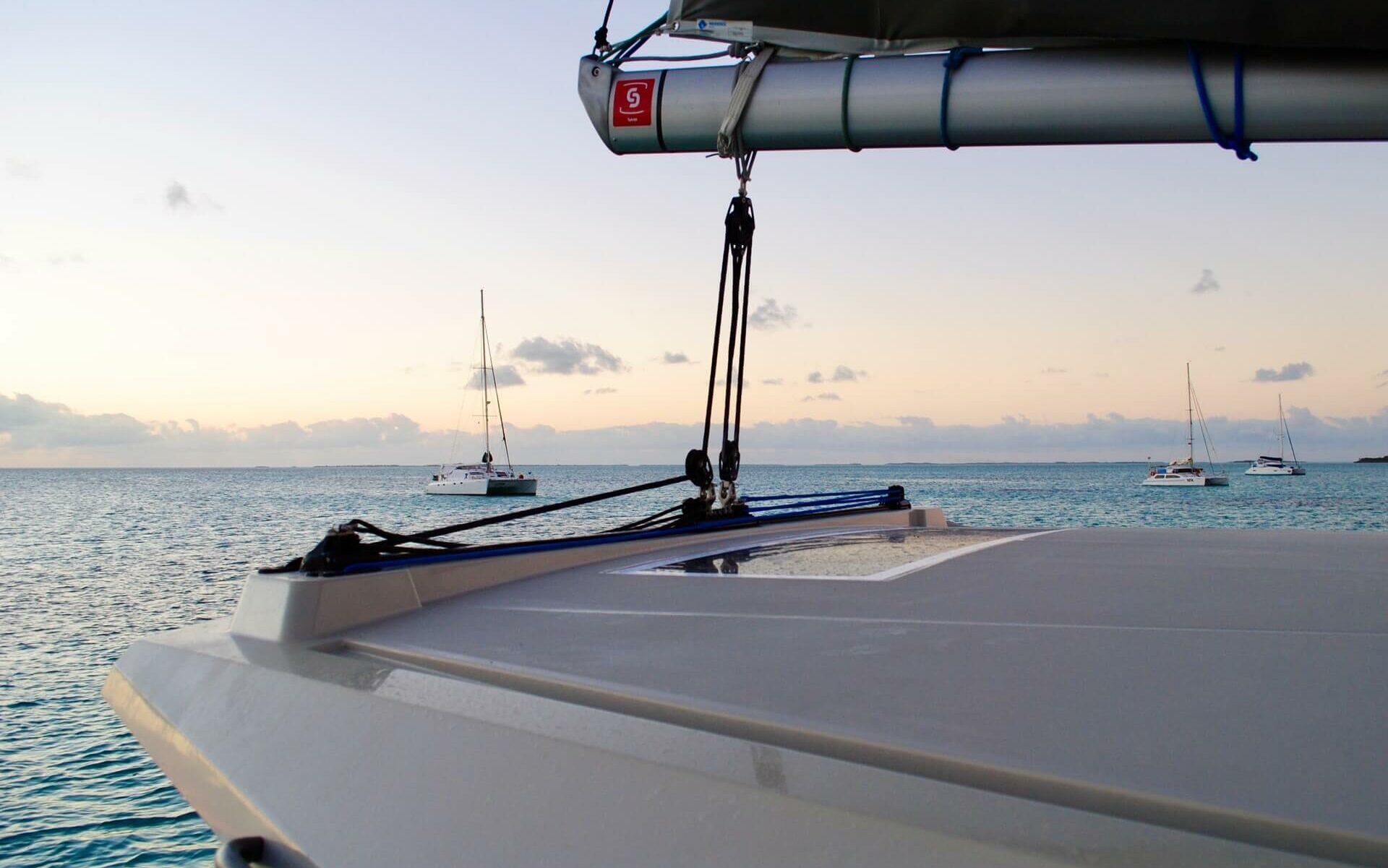 Sailboat View at Sunset White sailboats at anchor in the Bahamas