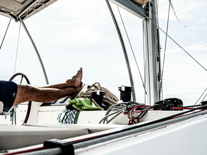 A man puts his feet up while relaxing on his boat