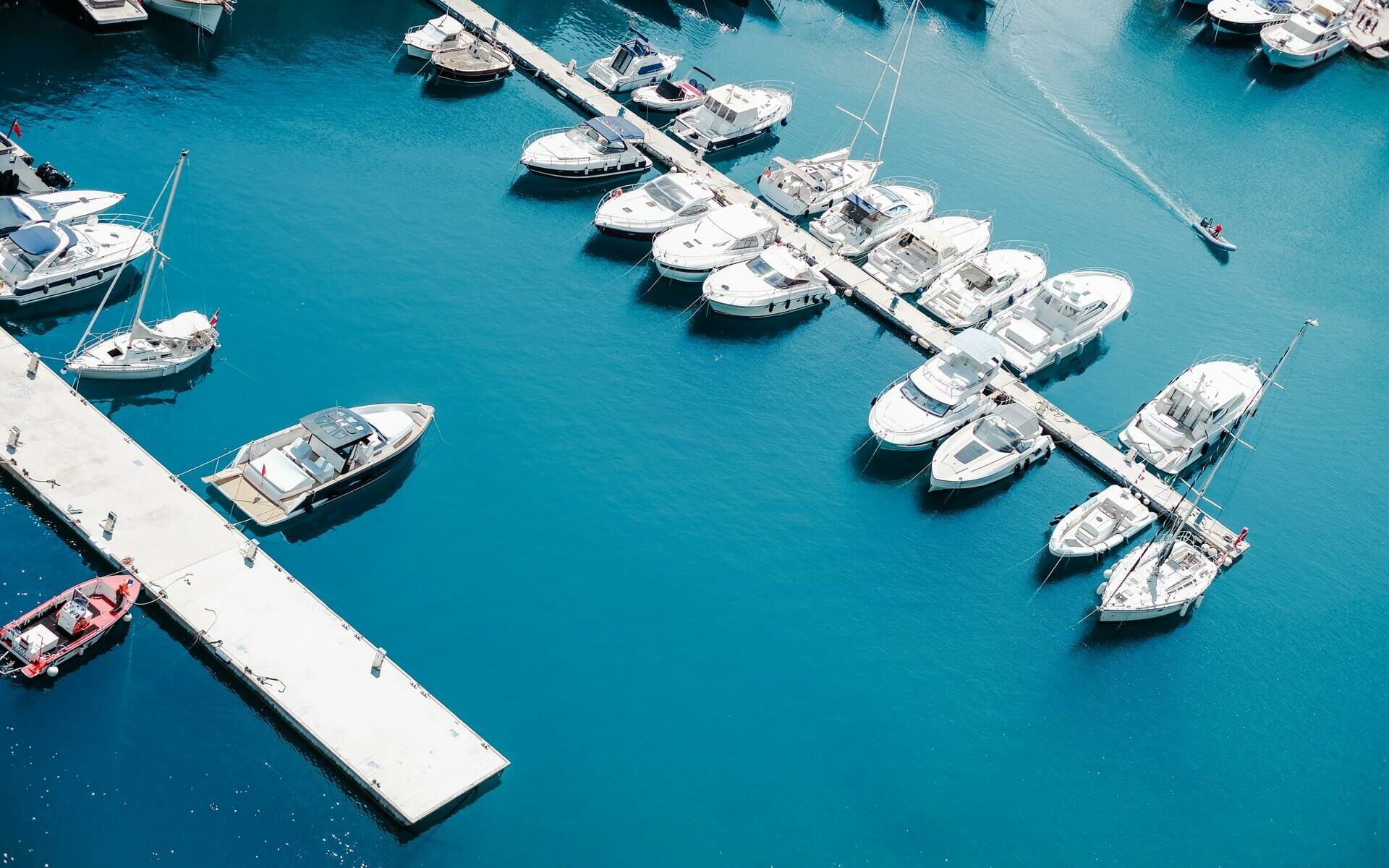 Various types of vessels at boat slips in a marina Various types of vessels at boat slips in a marina