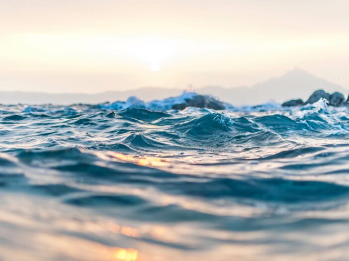 waves on the ocean surface moving with the tides