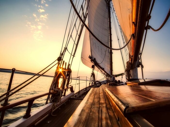 view of the sunset from a sailboat using a wind vane system to steer
