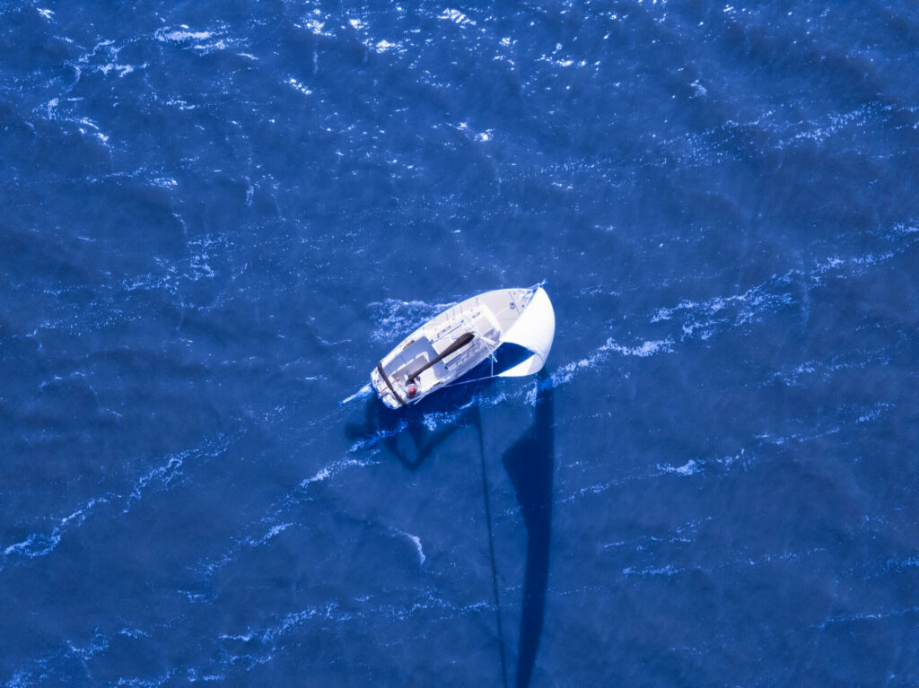 Sailboat sailing through the ocean Sailboat sailing through the ocean